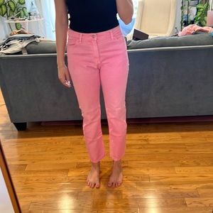Pink mid-rise straight leg jeans.